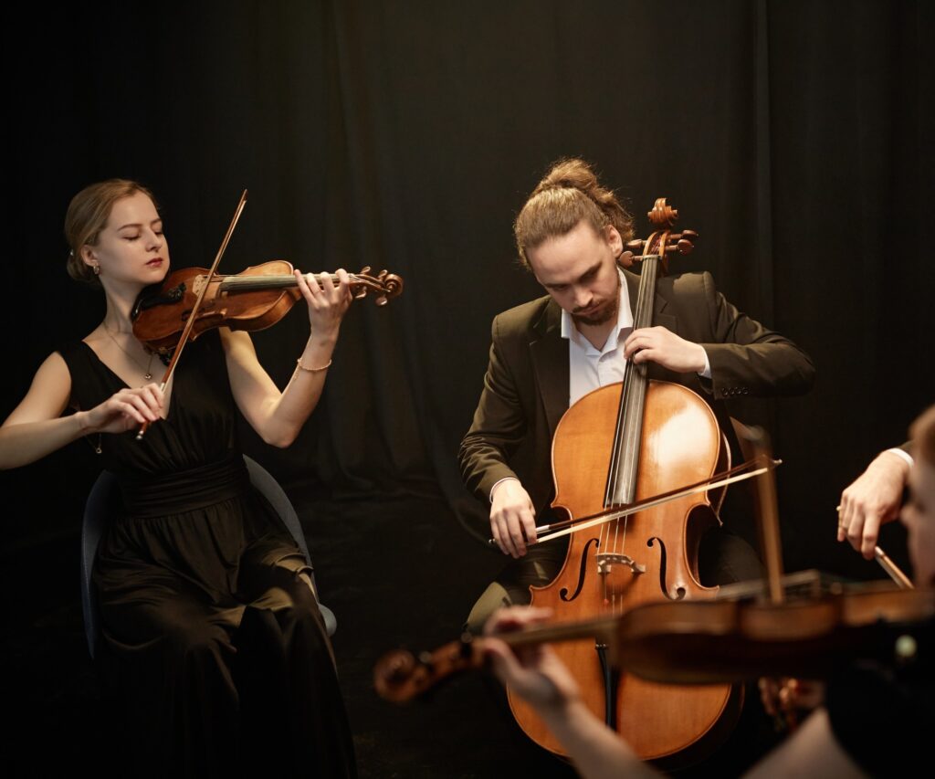 String quartet performing on stage with instruments.
